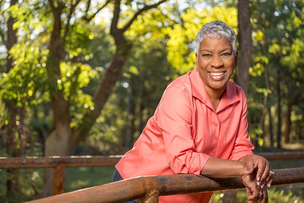 Nurturing women for leadership - confident woman standing on a bridge