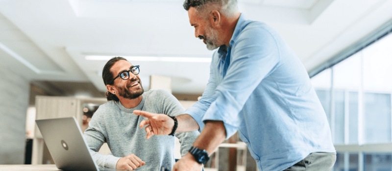Colleagues smiling and communicating with positive body language