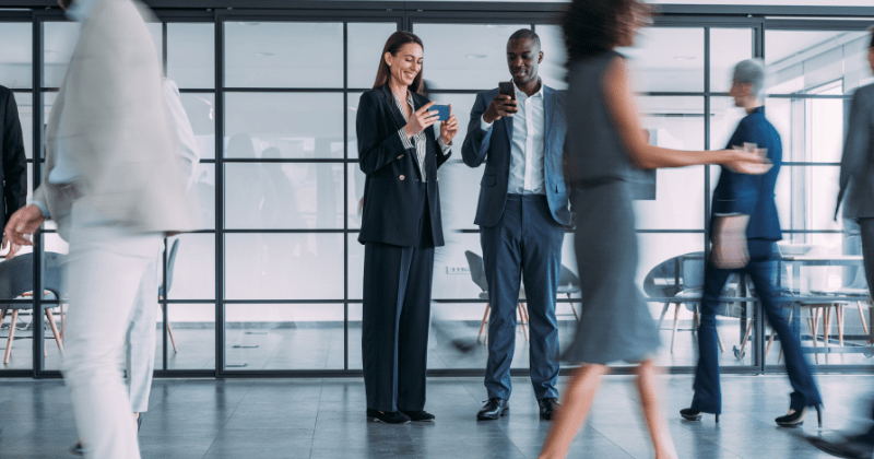 colleagues in a busy office in their phones