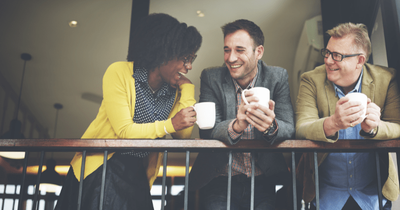 Happy colleagues enjoying each others' company after mastering communication